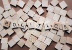 The word politics spelled with scrabble tiles